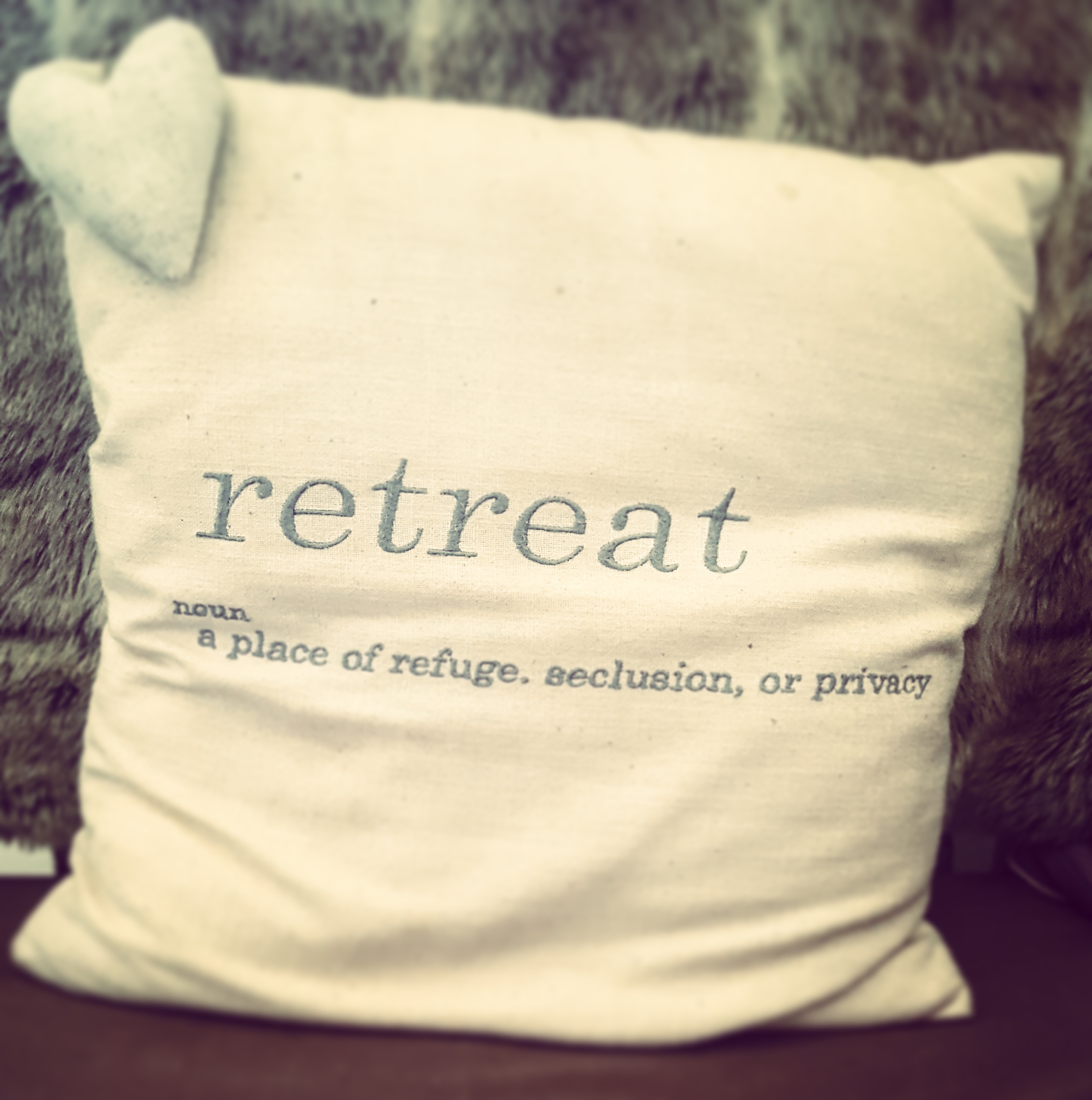 cushion with Retreat written on it on The Last Krystallos blog