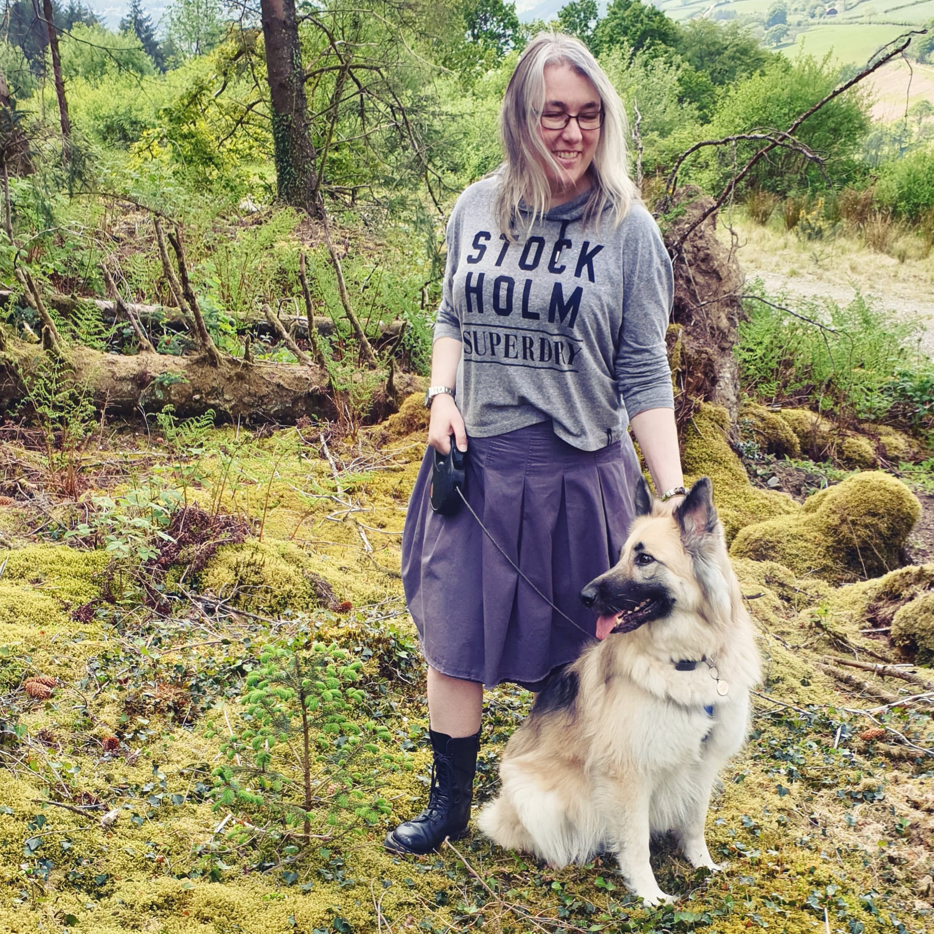 Lisa Shambrook in a mossy forest with Kira German Shepherd